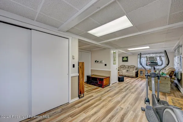 a view of an empty room with stairs wooden floor and closet