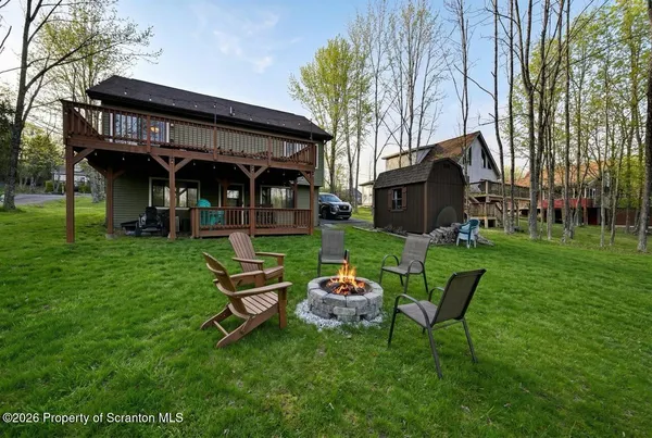 a view of a chair and table in backyard of the house