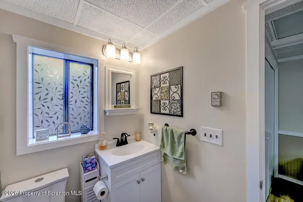 a bathroom with a sink a mirror and a window