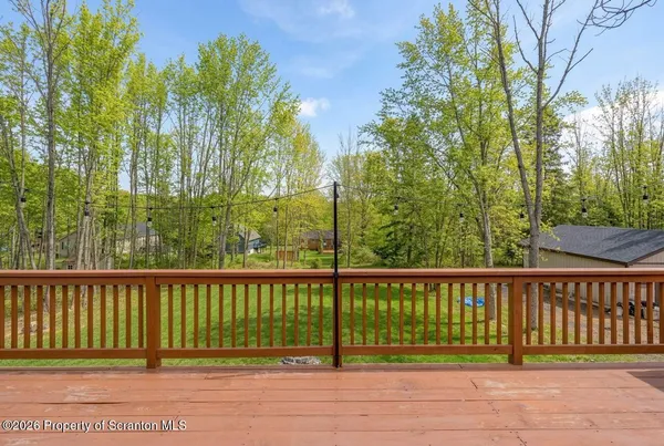 a view of a balcony with furniture and wooden floor