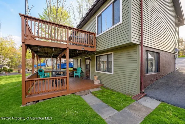 a view of a chair and table in backyard of the house