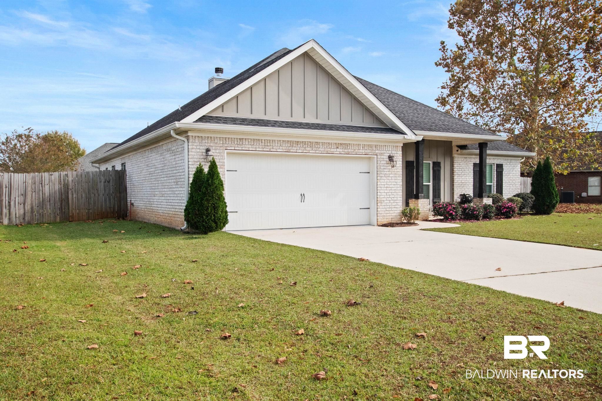 17376 Bankhead Boulevard Fairhope, AL 36532 - Photo 4 of 73 View of front of home with brick siding, board and batten siding, a garage, and concrete driveway