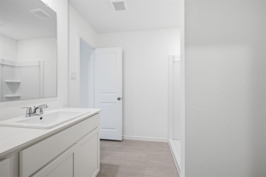 2128 Doc Holliday Road Joshua, TX 76058 - Photo 22 of 28 Bathroom with a white vanity featuring a single basin sink and chrome faucet