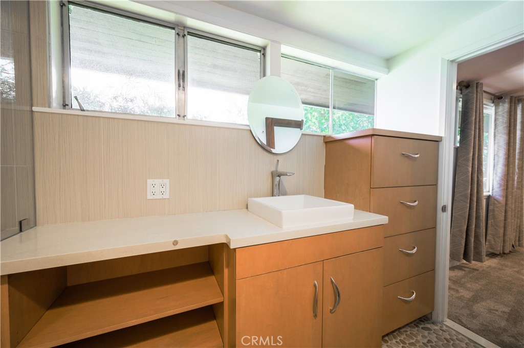 105 West Kenneth Road Glendale, CA 91202 - Photo 28 of 48 a bathroom with a sink and a mirror