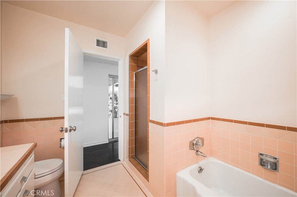 105 West Kenneth Road Glendale, CA 91202 - Photo 33 of 48 a bathroom with a bathtub and toilet