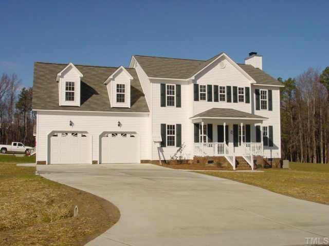 8731 Highmore Trail Raleigh, NC 27603 - Photo 1 of 1 a front view of a house with a yard