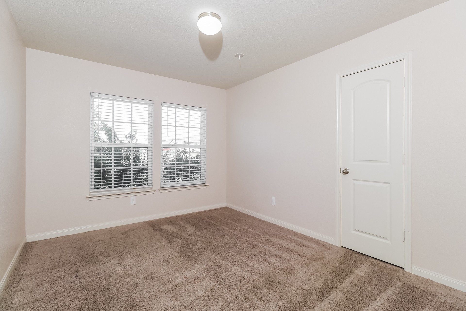 20017 Hubert R Humphrey Road Manor, TX 78653 - Photo 15 of 27 A well-lit room offering a neutral canvas for personalized decor and comfort.