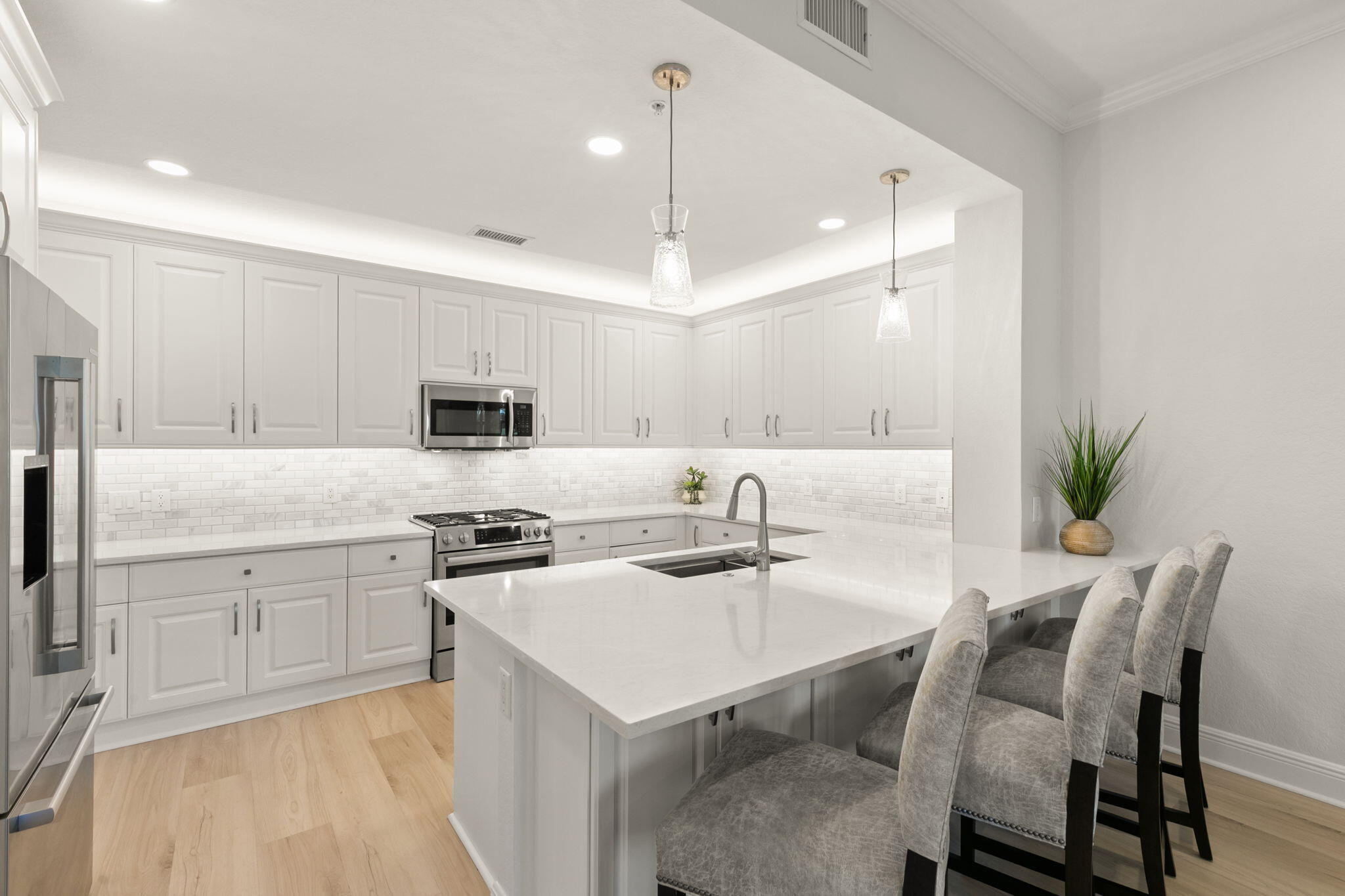 9213 Museo Circle, Unit 103 Naples, FL 34114 - Photo 5 of 47 a kitchen with a dining table chairs sink and stove