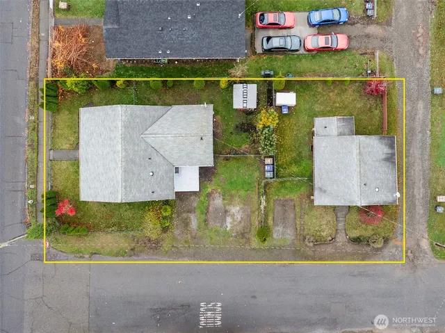 an aerial view of a houses with a yard