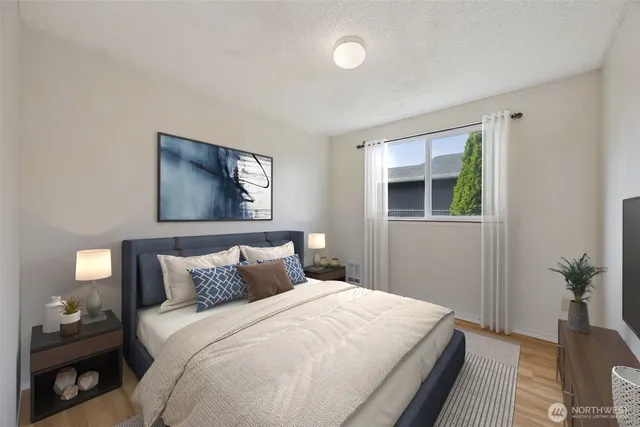 a bedroom with a bed and a painting on the wall