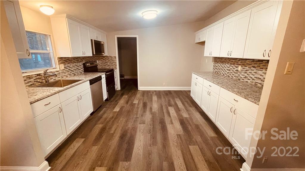 3246 Daystar Road Lancaster, SC 29720 - Photo 5 of 13 a kitchen with stove a sink and dishwasher with wooden floor