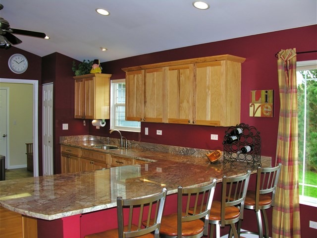 7209 Cornflower Way Spring Grove, IL 60081 - Photo 11 of 25 a kitchen with stainless steel appliances granite countertop a stove a sink and a microwave