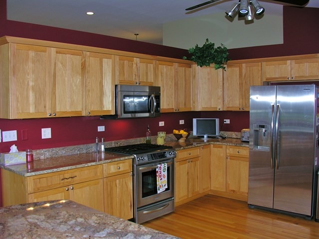 7209 Cornflower Way Spring Grove, IL 60081 - Photo 12 of 25 a kitchen with stainless steel appliances granite countertop a stove a sink dishwasher and a refrigerator