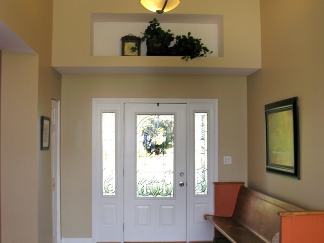 7209 Cornflower Way Spring Grove, IL 60081 - Photo 18 of 25 a hallway with a chair and a window