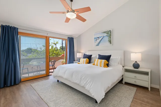 a bedroom with a large bed and a large window