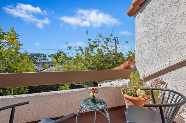 a view of a chairs and table in patio