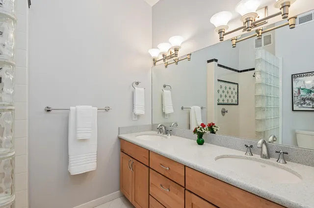 a bathroom with a double vanity sink and a mirror