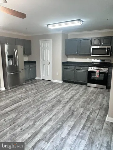a view of a kitchen with a sink and a refrigerator