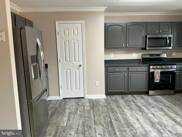 a kitchen with stainless steel appliances granite countertop a stove cabinets and a sink