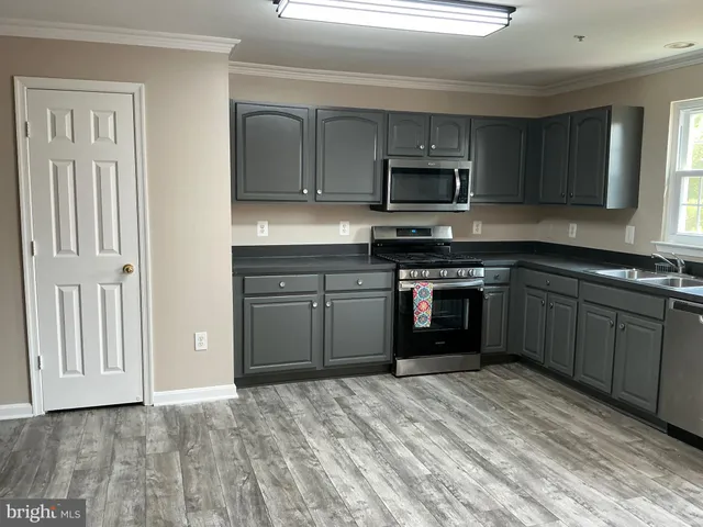 a view of a kitchen with a sink and cabinets