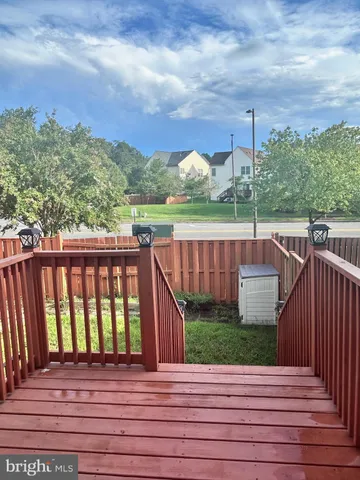 a view of a balcony with wooden floor and city view