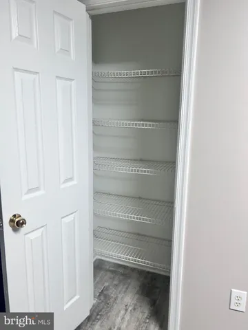 an empty room with a chandelier fan