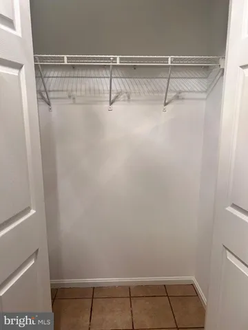 a white toilet sitting next to a white wall