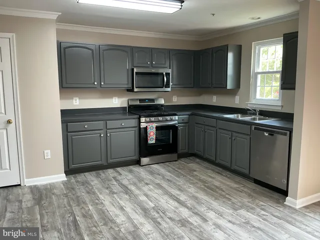 a kitchen with stainless steel appliances a stove and a refrigerator
