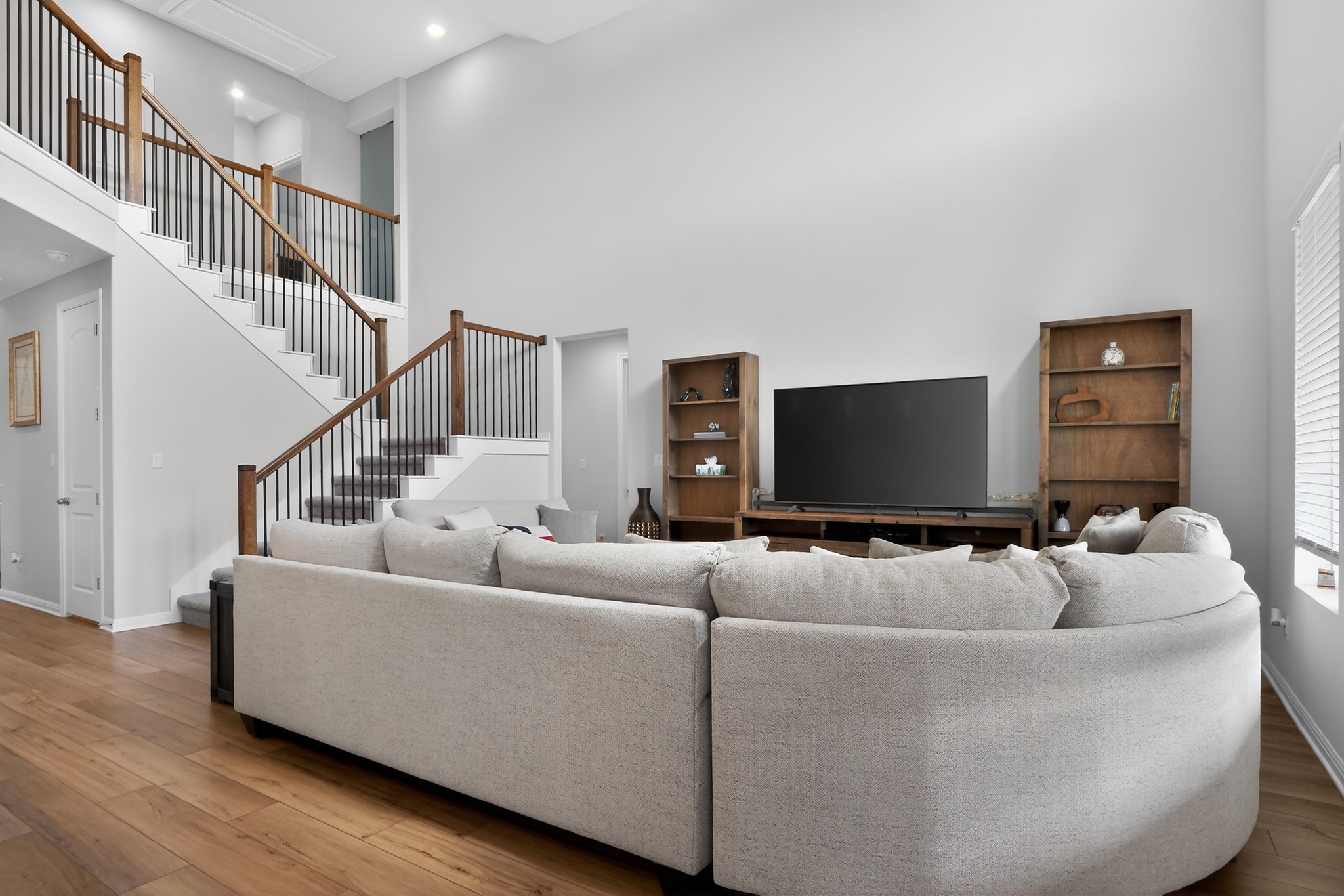 114 Bosco Road Hutto, TX 78634 - Photo 34 of 39 A well-lit living area features soaring ceilings and a stylish staircase.