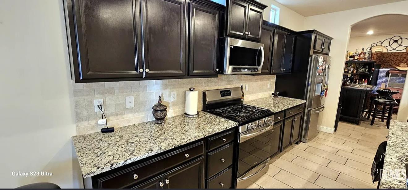 Undisclosed Address Shafter, CA 93263 - Photo 8 of 34 a kitchen with stainless steel appliances granite countertop a sink stove and refrigerator