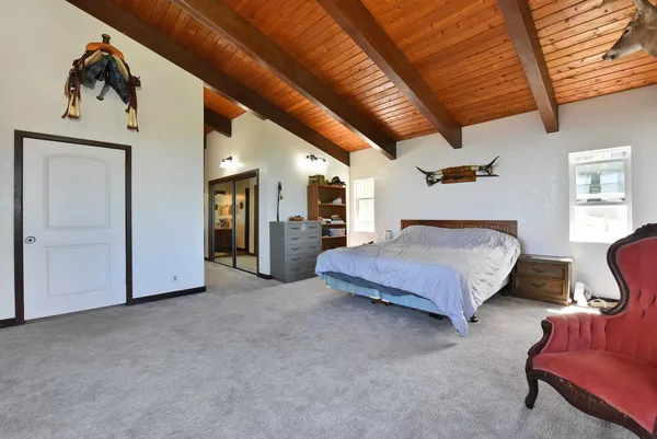 a spacious bedroom with a bed and furniture