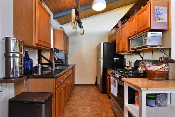 a kitchen with stainless steel appliances granite countertop a stove and a refrigerator
