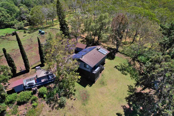 an aerial view of a house with a yard