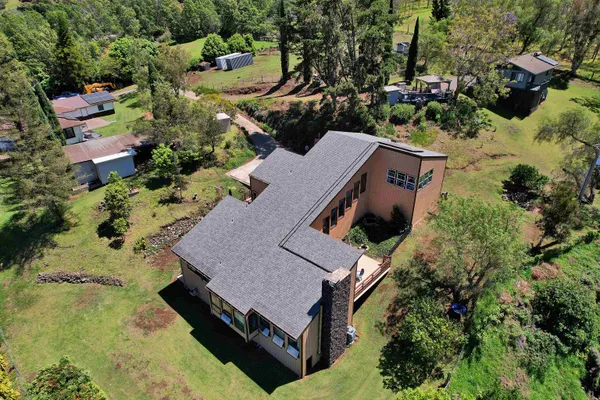 an aerial view of a house with a yard