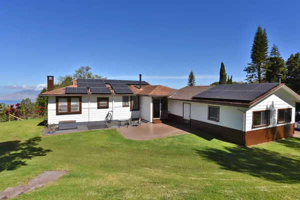 a view of a house with a yard porch and sitting area
