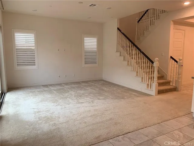 a kitchen with granite countertop a stove a sink and a refrigerator