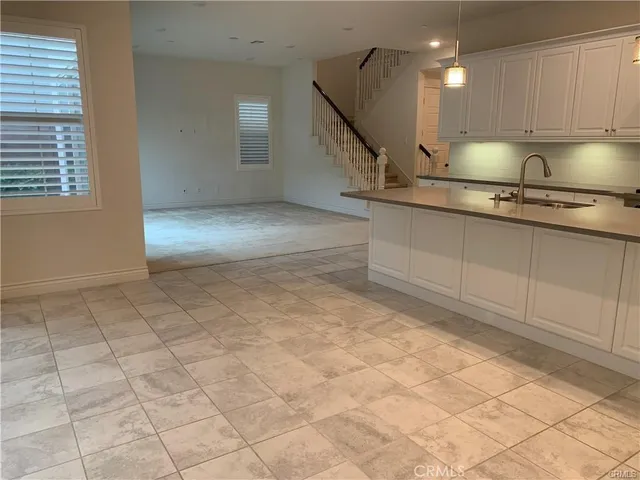 a large kitchen with stainless steel appliances granite countertop a sink a stove and cabinets