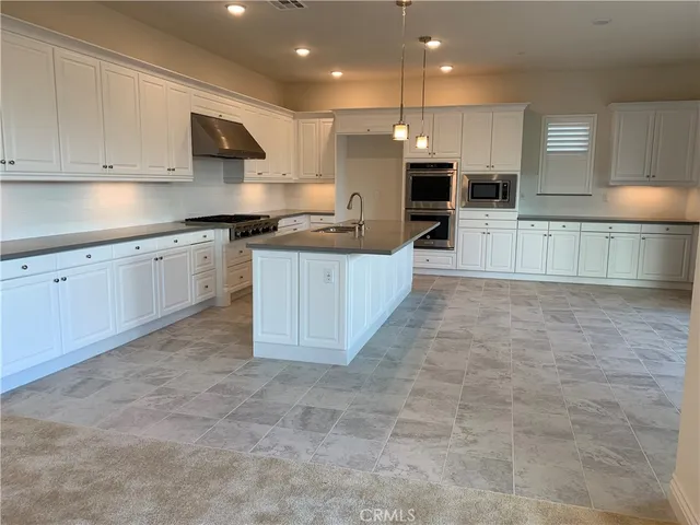 a close up of a stove top oven sitting inside of a kitchen