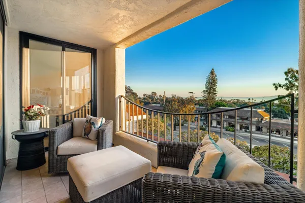 a view of a living room and a balcony
