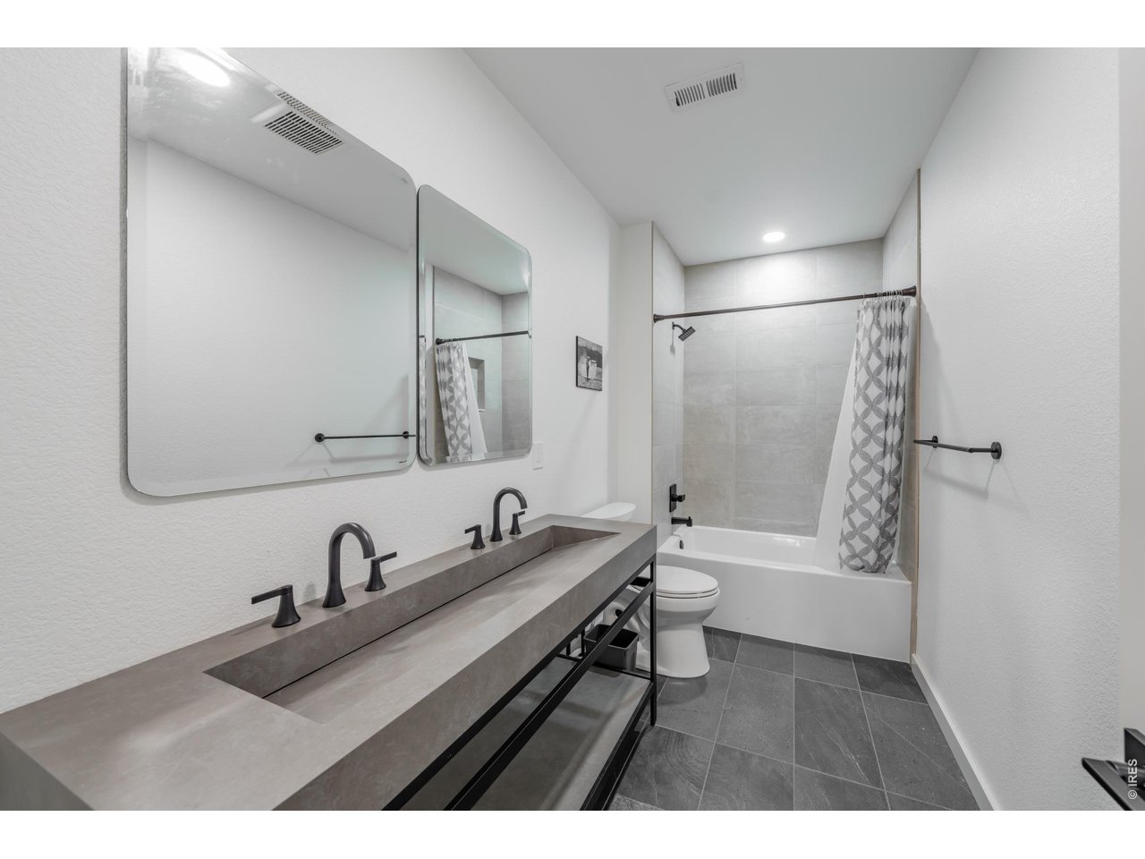2394 Davis Street Fort Collins, CO 80524 - Photo 19 of 29 a bathroom with a double vanity sink a toilet and a tub