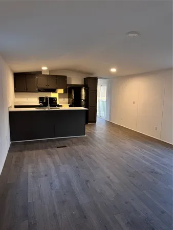 a view of kitchen and wooden floor