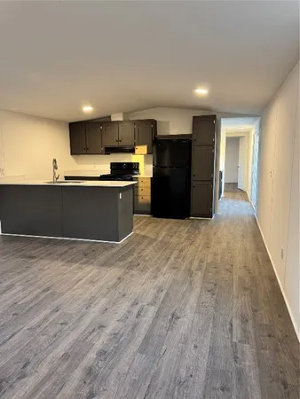 a large kitchen with stainless steel appliances granite countertop a large counter top and a stove top oven