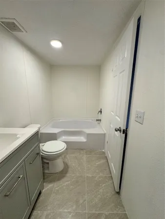 a bathroom with a toilet a sink and bathtub