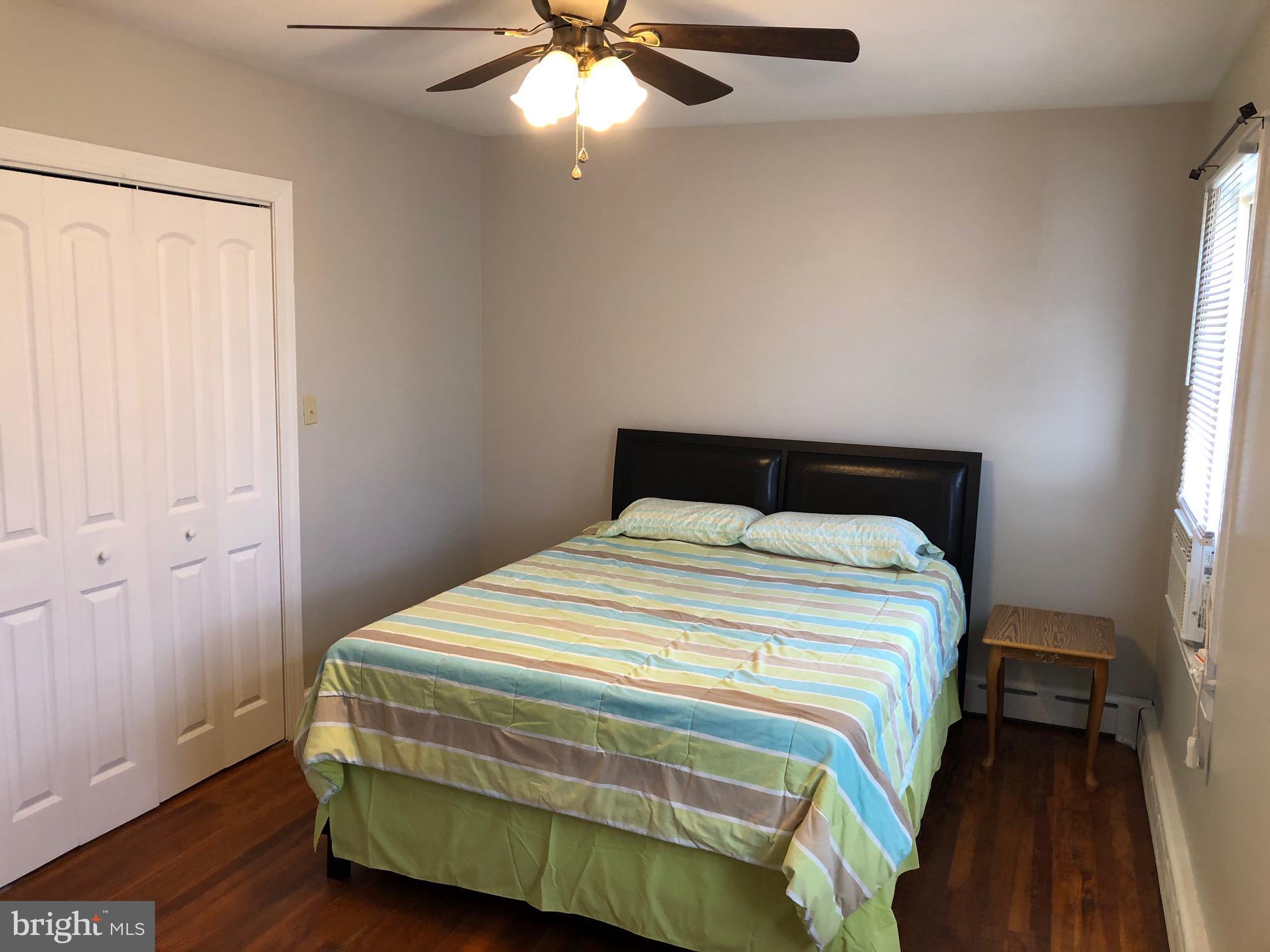 20618 Ridge Road Colonial Beach, VA 22443 - Photo 12 of 25 a bedroom with a bed and a chandelier