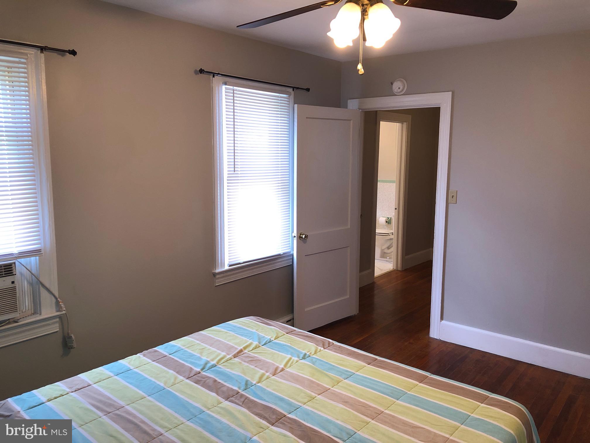 20618 Ridge Road Colonial Beach, VA 22443 - Photo 13 of 25 a bedroom with a bed and a chandelier