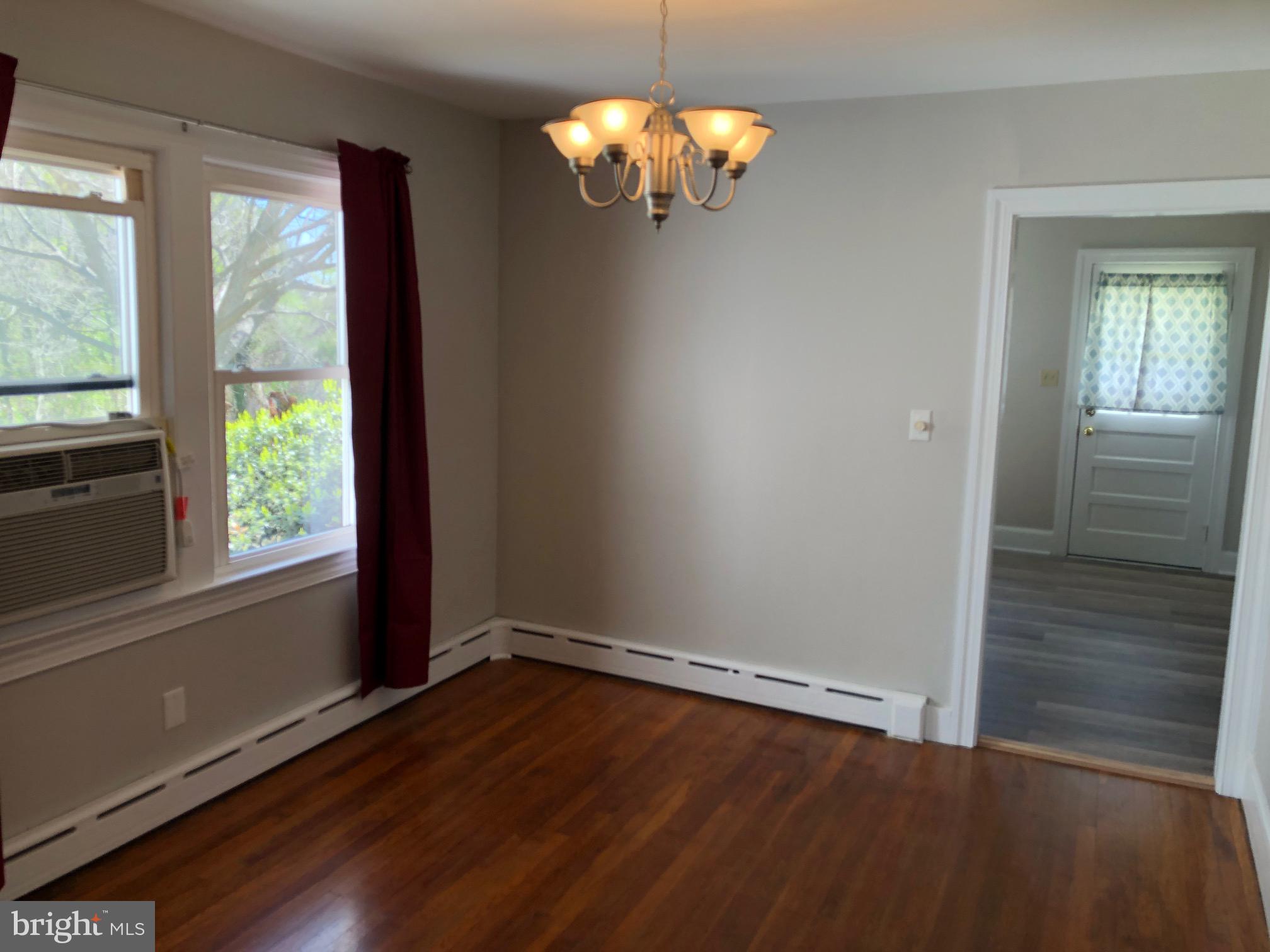 20618 Ridge Road Colonial Beach, VA 22443 - Photo 7 of 25 wooden floor in an empty room with a window