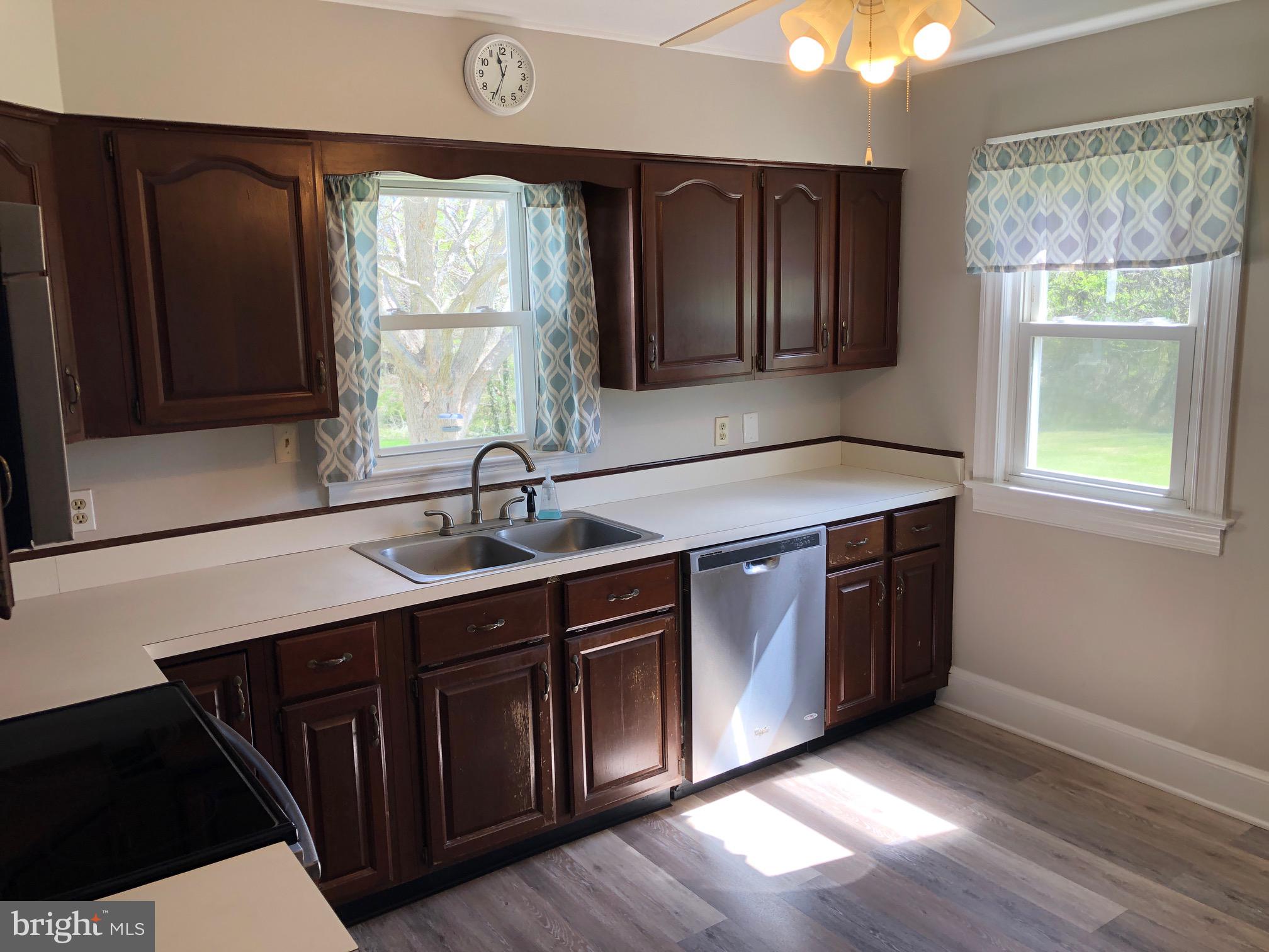 20618 Ridge Road Colonial Beach, VA 22443 - Photo 8 of 25 a kitchen with a sink window and cabinets
