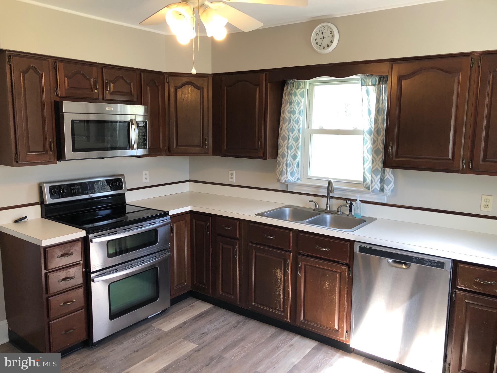 20618 Ridge Road Colonial Beach, VA 22443 - Photo 9 of 25 a kitchen with a sink stove and microwave