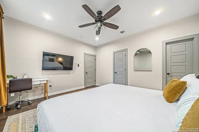 a bedroom with a bed and a chandelier