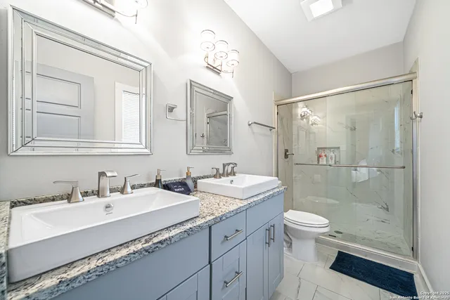 a bathroom with a double vanity sink mirror double shower and a bathtub